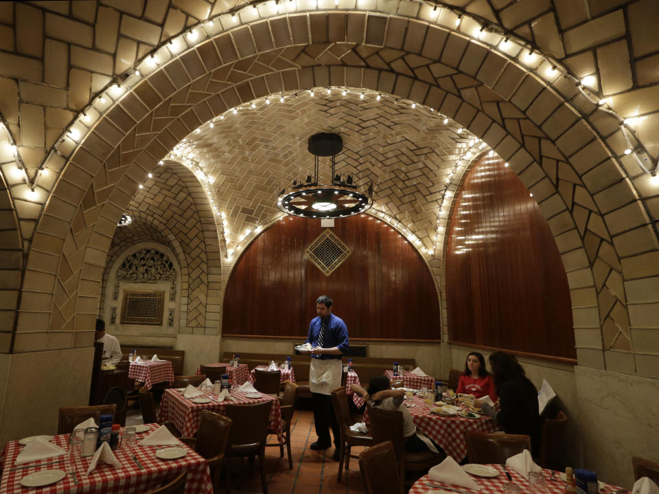A server works beneath the tiled and vaulted ceilings at The Oyster Bar at Grand Central Terminal in New York, Wednesday, Jan. 9, 2013. When the restaurant opened it's doors in 1913, Woodrow Wilson was president, the nation was on the verge of World War 1, and prohibition was six years away. (AP Photo/Kathy Willens)