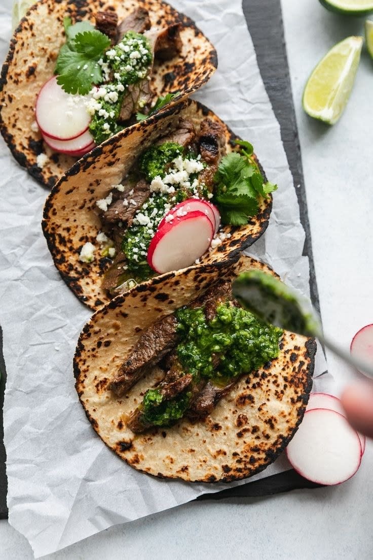 A carne asada taco with herb sauce.