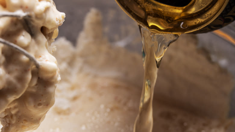 Beer pouring into batter with whisk