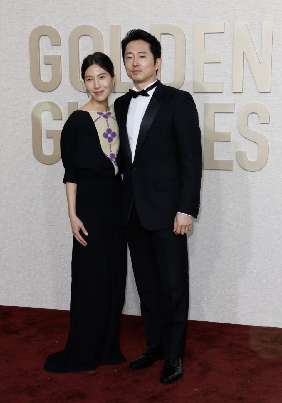 Joana Pak and Steven Yeun on the red carpet of the 81st Golden Globe Awards at the Beverly Hilton