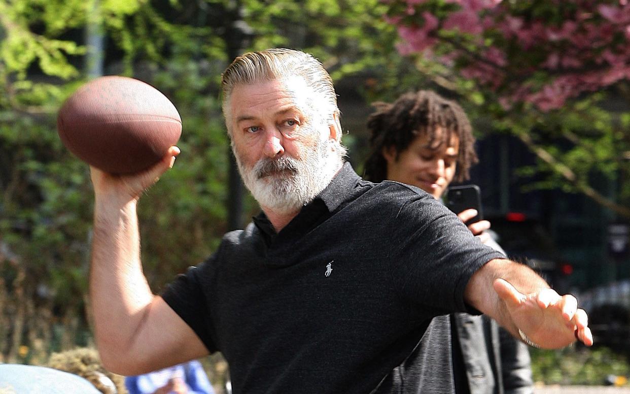 Alec Baldwin pictured playing football in Washington Square Park in New York - The Mega Agency