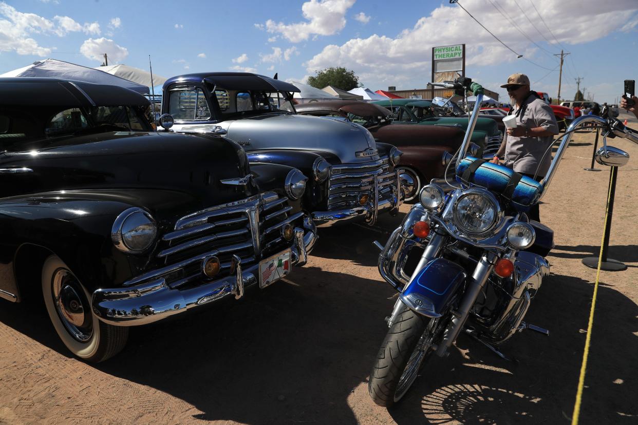 Vintage cars are part of the show as spectators enjoy music, food, and cannabis-themed merchandise at the GT 420 Music Fest in Chaparral, New Mexico, on Saturday, April 20.