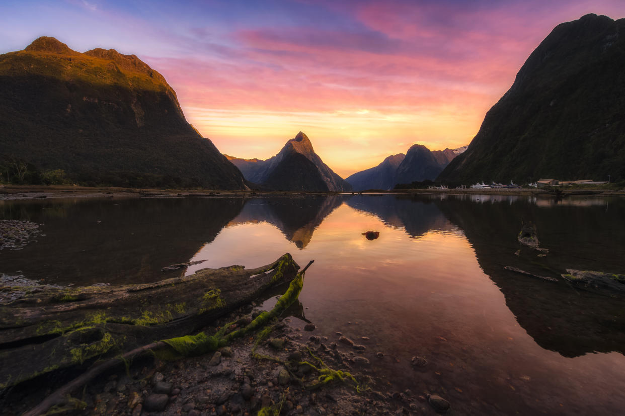 Milford sound in the morning sunrise and reflection of the beautiful mountain in the lake