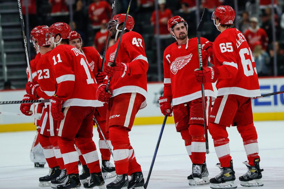 Red Wings center Dylan Larkin, second from right, talks to defenseman Danny DeKeyser (65). DeKeyser has been in pandemic protocol since before Thanksgiving, and Larkin missed one period after a false positive.