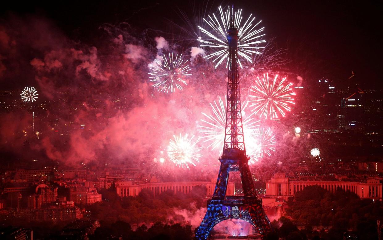 Fireworks explode in the sky around the Eiffel Tower, at the end of Bastille Day events in Paris on July 14, 2018 - REUTERS