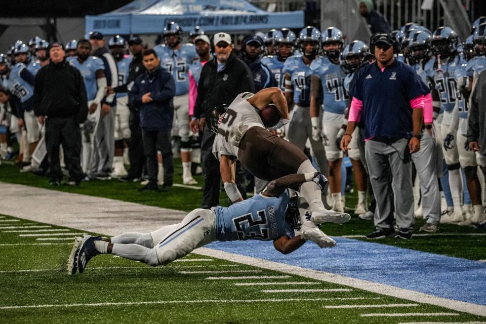 URI defensive back Jordan Jones tackles Brown receiver Hayes Sutton near the sideline last October in Kingston, Rhode Island.