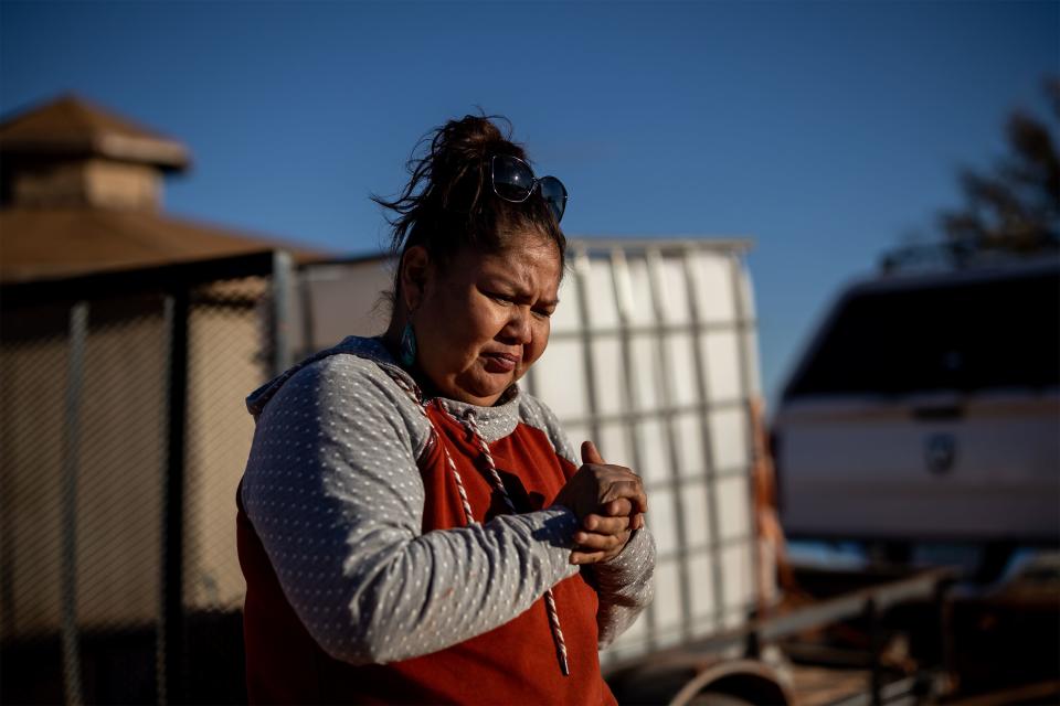 Freda Castillo waits for the water she hauled from Kayenta, Arizona, to fill the underground cistern that supplies her mother’s home 35 miles away on the Navajo Nation. | Spenser Heaps, Deseret News