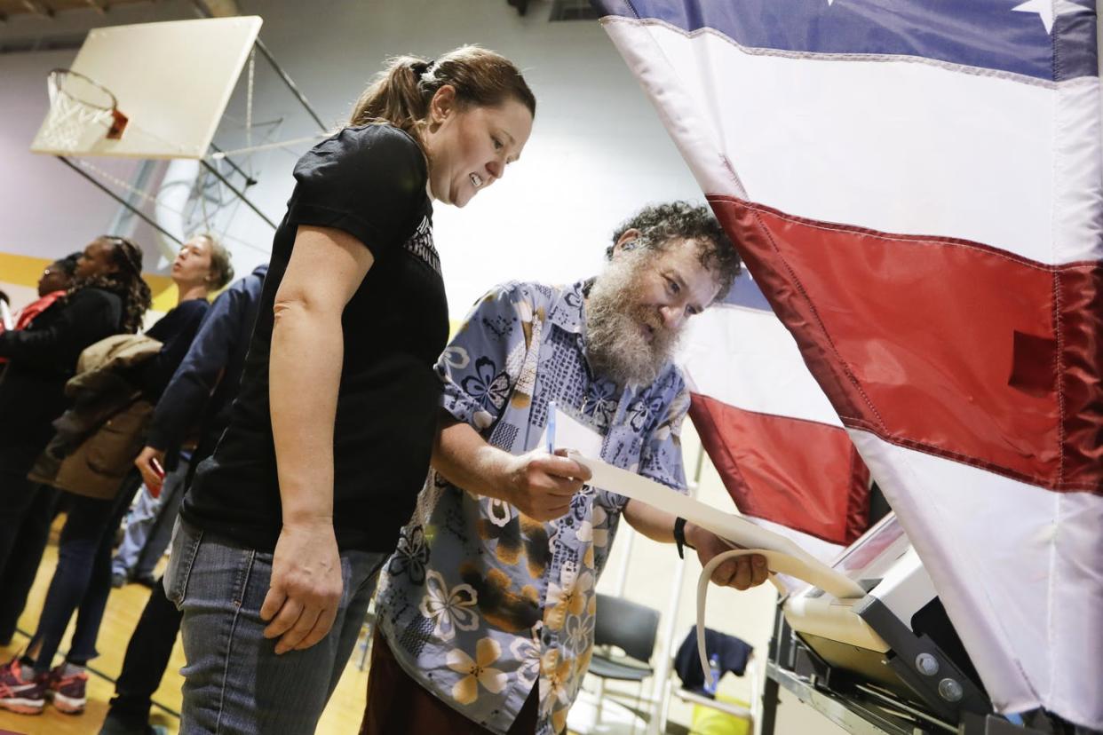 <span class="caption">Voting machine operator David Schaefer, right, helps voter Kaitron Gordon with her ballot on Tennessee's Super Tuesday primary in Nashville after deadly overnight tornadoes delayed the start of voting. </span> <span class="attribution"><a class="link " href="http://www.apimages.com/metadata/Index/Election-2020-Tennessee-Primary/a3f7c17f1fb340d1ab59126dcaa81b73/35/0" rel="nofollow noopener" target="_blank" data-ylk="slk:AP/Mark Humphrey;elm:context_link;itc:0;sec:content-canvas">AP/Mark Humphrey</a></span>