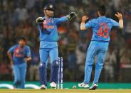 Cricket - New Zealand v India - World Twenty20 cricket tournament - Nagpur, India, 15/03/2016. India's captain and wicketkeeper Mahendra Singh Dhoni and his teammate Suresh Raina (R) celebrate the dismissal of New Zealand's captain Kane Williamson. REUTERS/Danish Siddiqui