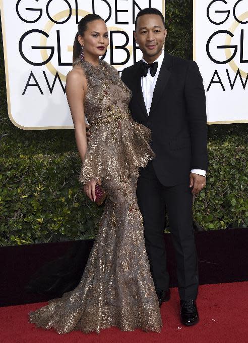 Chrissy Teigen, left, and John Legend arrive at the 74th annual Golden Globe Awards at the Beverly Hilton Hotel on Sunday, Jan. 8, 2017, in Beverly Hills, Calif. (Photo by Jordan Strauss/Invision/AP)