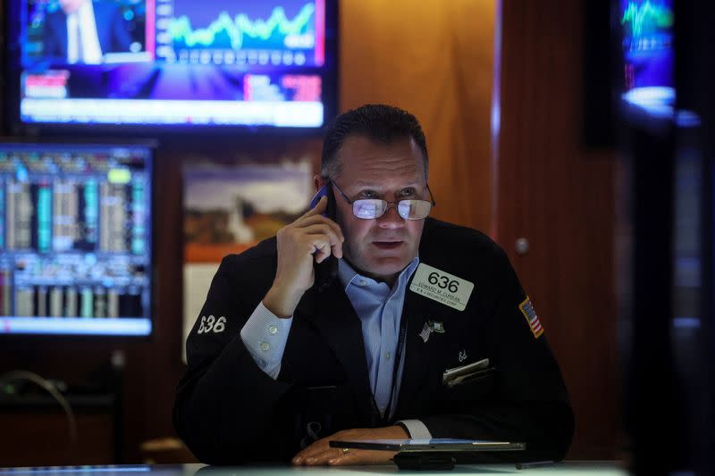 Traders work on the floor of the NYSE in New York