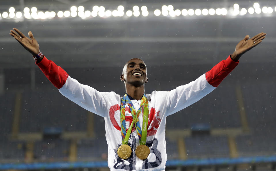 FILE Britain's Mo Farah celebrates winning the gold medal, in the men's 5000-meter medals ceremony, during the athletics competitions of the 2016 Summer Olympics at the Olympic stadium in Rio de Janeiro, Brazil, Saturday, Aug. 20, 2016. Four-time Olympic champion Mo Farah has disclosed he was brought into Britain illegally from Djibouti under the name of another child. The British athlete made the revelation in a BBC documentary. (AP Photo/Jae C. Hong, File)