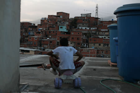 Andrew rides a small tricycle on the rooftop of his family house in Caracas's Catia neighbourhood in Venezuela, April 2, 2019. REUTERS/Ivan Alvarado