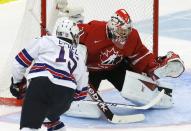 Canada's goalie Zachary Fucale (R) makes a save against United States' Jack Eichel during the first period of their IIHF World Junior Championship ice hockey game in Malmo, Sweden, December 31, 2013. REUTERS/Alexander Demianchuk (SWEDEN - Tags: SPORT ICE HOCKEY)