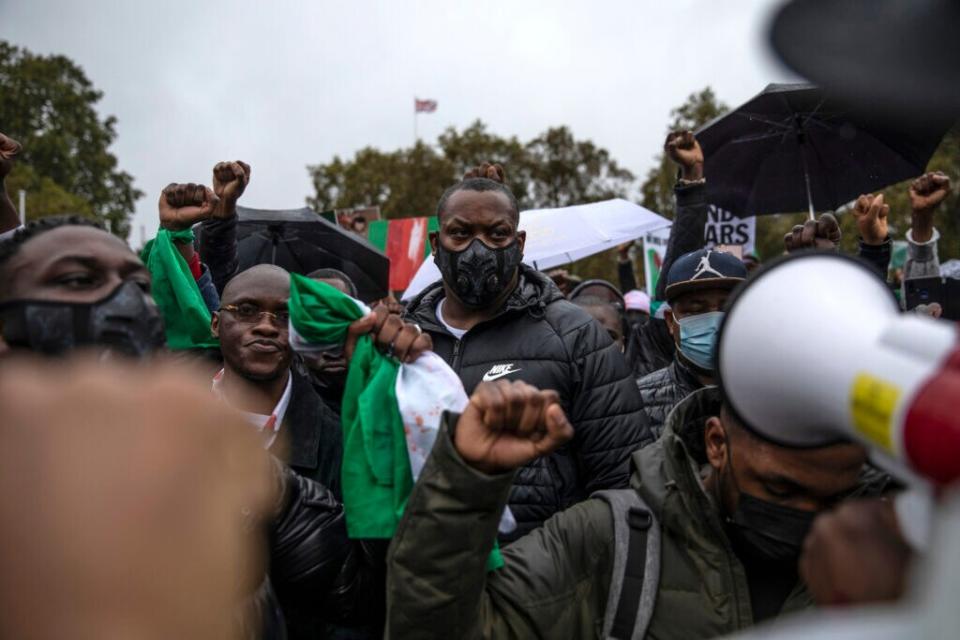 Protesters hold placards and signs calling for the end of police killings of the public in Nigeria, during a demonstration on October 21, 2020 in London, England. Nigerian police opened fire on protestors in Lagos yesterday after 12 days of anti-police demonstrating. Nigerians are protesting against police brutality carried out by a unit of the Nigerian police force called SARS (the Special Anti-Robbery Squad) (Photo by Dan Kitwood/Getty Images)