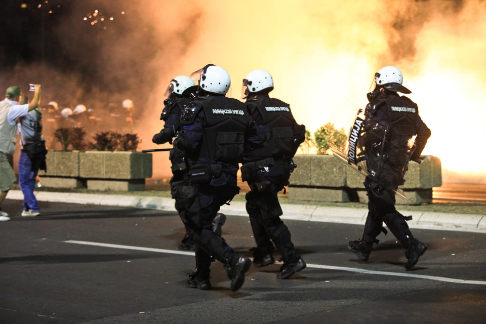 BELGRADE, SERBIA - JULY 8: Police officers intervene in protesters during a protest against new measures to curb the spread of the novel coronavirus in Belgrade, Serbia on July 8, 2020. Large numbers of people gathered in front of the National Assembly Building in Belgrade after President Aleksandar Vucic announced a weekend curfew in an effort to combat the disease.Protesters clashed with police while attempting to enter the building as gendarmerie forces set up a cordon on the steps in front of its entrance. (Photo by Milos Miskov/Anadolu Agency via Getty Images)