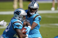 Carolina Panthers quarterback Teddy Bridgewater hands off to running back Mike Davis (28) during the second half of an NFL football game in Charlotte, N.C., Sunday, Oct. 18, 2020. (AP Photo/Brian Blanco)