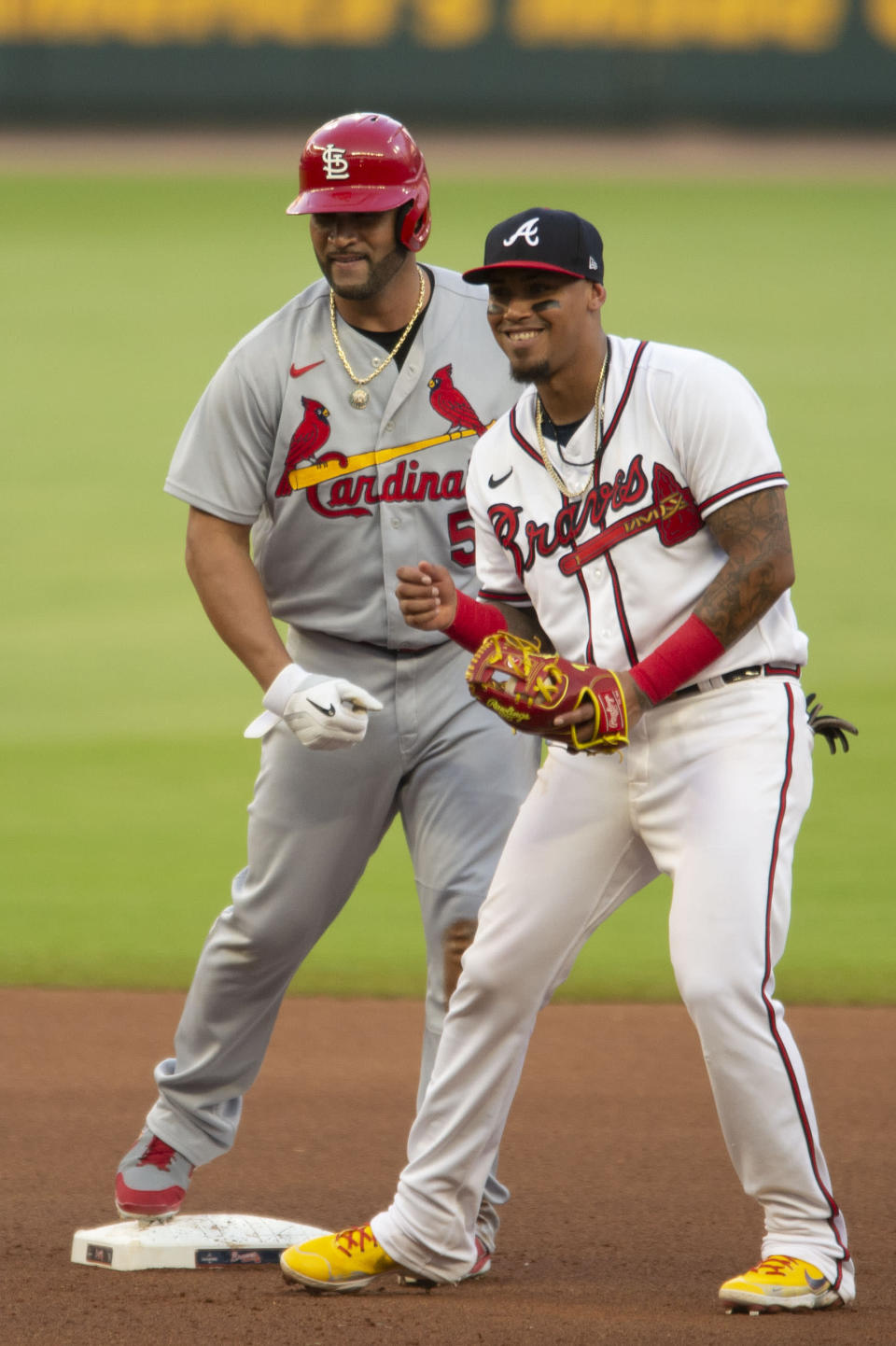 St. Louis Cardinals' Albert Pujols stands with Atlanta Braves second baseman Orlando Arcia after hitting a double during the third inning of a baseball game Wednesday, July 6, 2022, in Atlanta. (AP Photo/Edward M. Pio Roda)