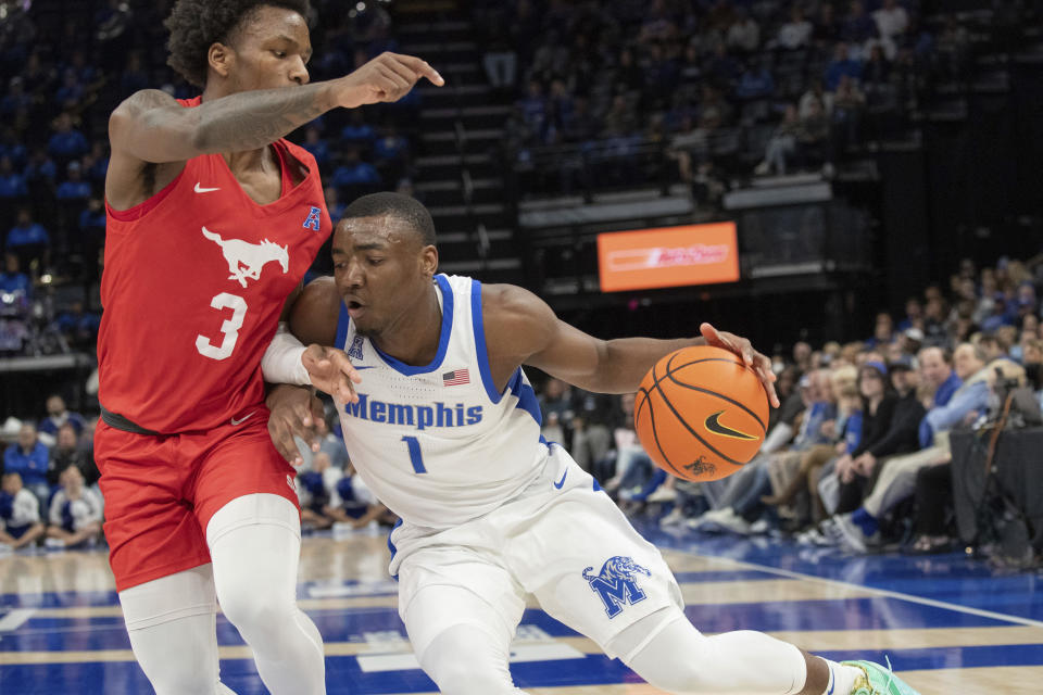 SMU guard Chuck Harris (3) defends Memphis guard Jayhlon Young (1) during the first half of an NCAA college basketball game Sunday, Jan. 7, 2024, in Memphis, Tenn. (AP Photo/Nikki Boertman)