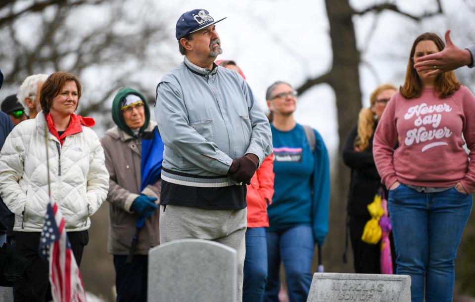 Steve Kuntz, center, listens during a Civil War-themed walking tour of Des Moines' historic Woodland Cemetery.