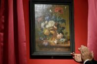The "Vase of Flowers" painting by Jan van Huysum, is unveiled during a ceremony at the Pitti Palace, part of the Uffizi Galleries, in Florence, Italy, Friday, July 19, 2019. Germany returned the Dutch still-life after it was stolen by Nazi troops during WWII. (AP Photo/Gregorio Borgia)