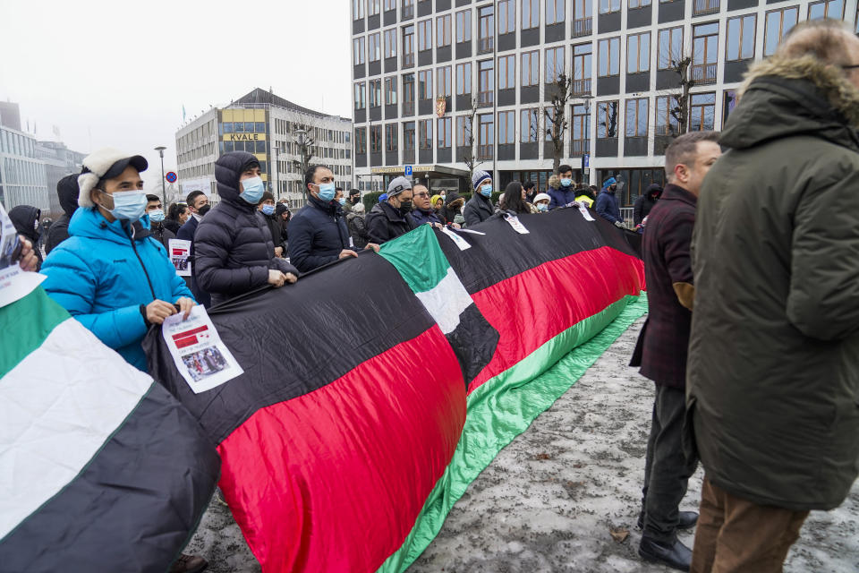 People protest outside the Ministry of Foreign Affairs to demonstrate against the Taliban being in Norway, in Oslo, Sunday, Jan. 23, 2022. Three days of talks between a Taliban delegation led by acting Foreign Minister Amir Khan Muttaqi, the Norwegian government and several allied countries have started in Oslo amid a deteriorating humanitarian situation in Afghanistan. (Torstein Boe/NTB Scanpix via AP)