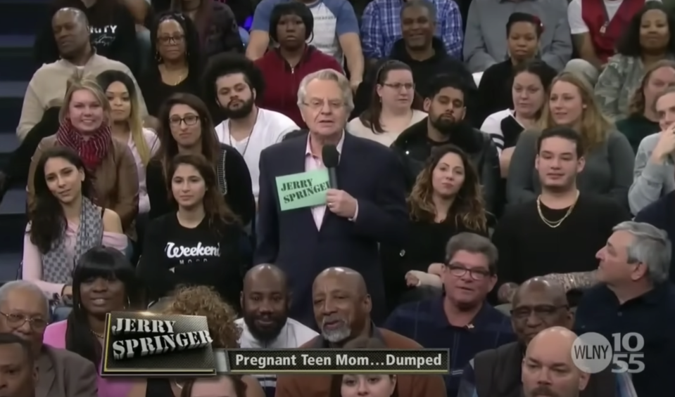 Jerry Springer standing in the audience with the chyron "Pregnant Teen Mom Dumped"