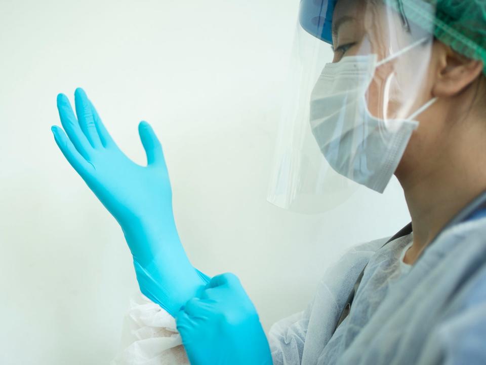 Female doctor teaching How to wearing Surgical mask for protect Covid-19 (coronavirus) and pm 2.5 air pollution - stock photo