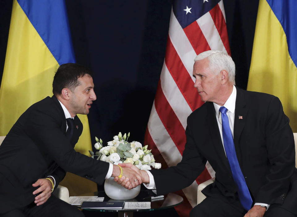 FILE - In this file photo taken on Sept. 1, 2019, Ukraine's President Volodymyr Zelenskiy, left, shakes hands with U.S. Vice President Mike Pence, in Warsaw, Poland. Zelenskiy, the comedian elected Ukraine’s leader in April, took office pledging to focus on ending the deadly separatist fighting in the country’s east, fomented by Russia. But now, barely 100 days in power, he finds himself at the center of a political furor involving the United States, Ukraine’s friend and backer. (AP Photo/Petr David Josek, File)
