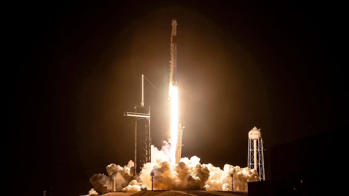  A rocket launches at night. 