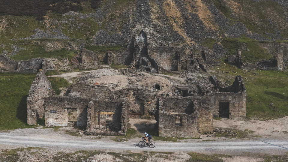 Gravel rider passing the Old Gang Smelt Mill