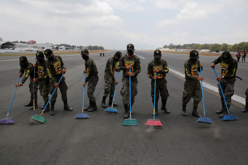 FILE PHOTO: Soldiers sweep volcanic ashes at La Aurora International Airport in Guatemala City