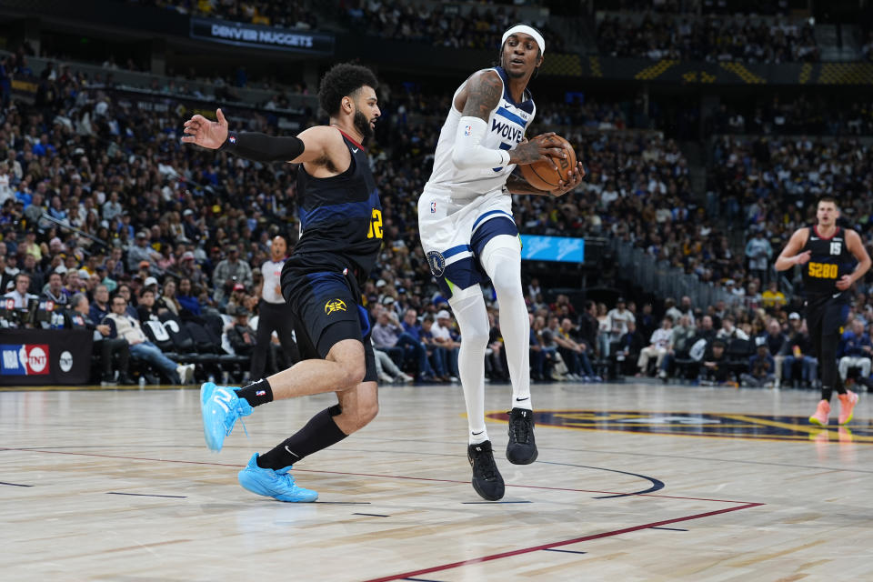 Minnesota Timberwolves forward Jaden McDaniels, right, drives to the basket as Denver Nuggets guard Jamal Murray defends during the second half of Game 2 of an NBA basketball second-round playoff series Monday, May 6, 2024, in Denver. (AP Photo/David Zalubowski)