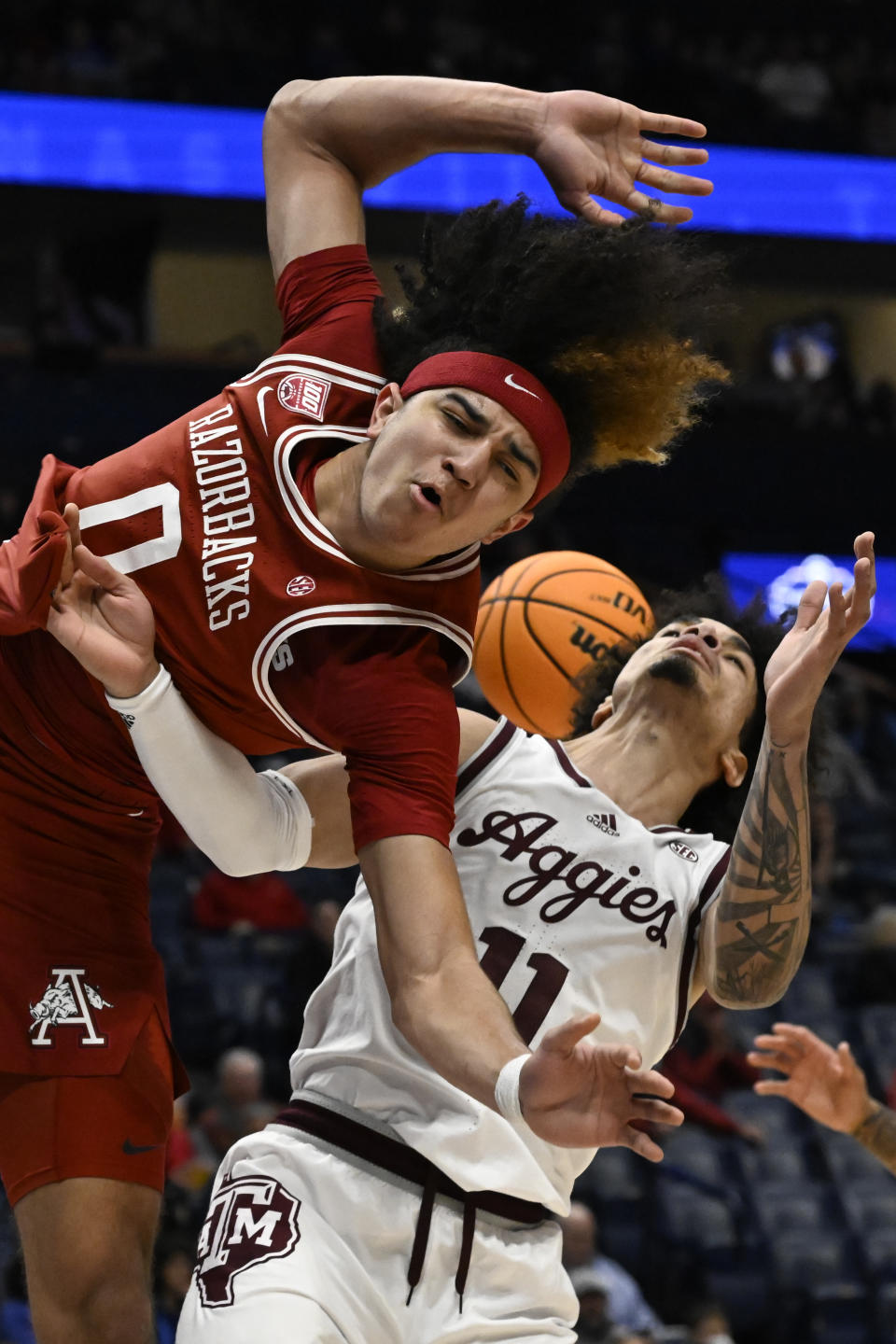 Arkansas guard Anthony Black (0) loses the ball shooting as Texas A&M forward Andersson Garcia (11) defends during the first half of an NCAA college basketball game in the quarterfinals of the Southeastern Conference Tournament, Friday, March 10, 2023, in Nashville, Tenn.(AP Photo/John Amis)