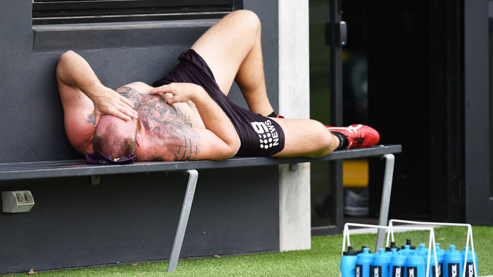 Pictured here, Matt Lodge lies in pain after suffering a suspected ACL injury.