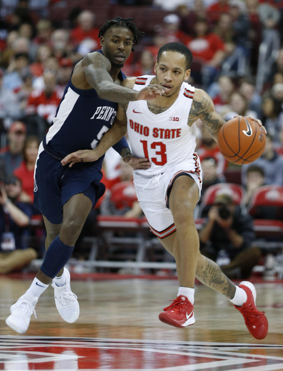 Ohio State's C.J. Walker, right, dribbles up court as Penn State's Jamari Wheeler defends during the second half of an NCAA college basketball game Saturday, Dec. 7, 2019, in Columbus, Ohio. Ohio State beat Penn State 104-74. (AP Photo/Jay LaPrete)