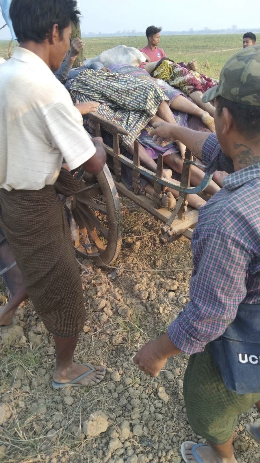 Bodies are piled on a cart after being discovered then collected in Nyaung Yin village, Myinmu township in the Sagaing region, central Myanmar on Thursday, March 2, 2023. Soldiers in Myanmar rampaged through several villages, raping, beheading and killing at least 17 people, residents said, in the latest of what critics of the ruling military say are a series of war crimes since the army seized power two years ago. (UGC via AP)