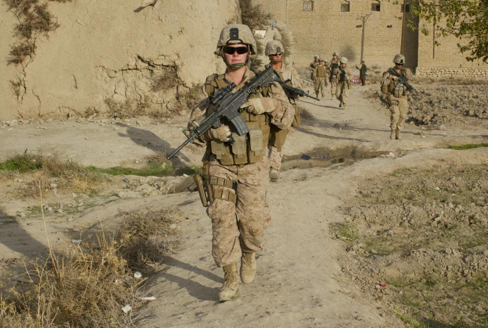 MUSA QALA, AFGHANISTAN - NOVEMBER 20: (SPAIN OUT, FRANCE OUT, AFP OUT) Lance Corporal Kristi Baker,21, US Marine with the FET (Female Engagement Team) 1st Battalion 8th Marines, Regimental Combat team II patrols with other Marines on November 20, 2010 in Musa Qala, Afghanistan. There are 48 women presently working along the volatile front lines of the war in Afghanistan deployed as the second Female Engagement team participating in a more active role, gaining access where men can't. The women, many who volunteer for the 6.5 month deployment take a 10 week course at Camp Pendleton in California where they are trained for any possible situation, including learning Afghan customs and basic Pashtun language. (Photo by Paula Bronstein/Getty Images)