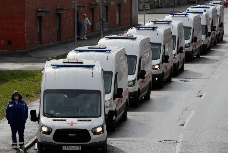 FILE PHOTO: Ambulances queue before driving onto the territory of a hospital in Saint Petersburg