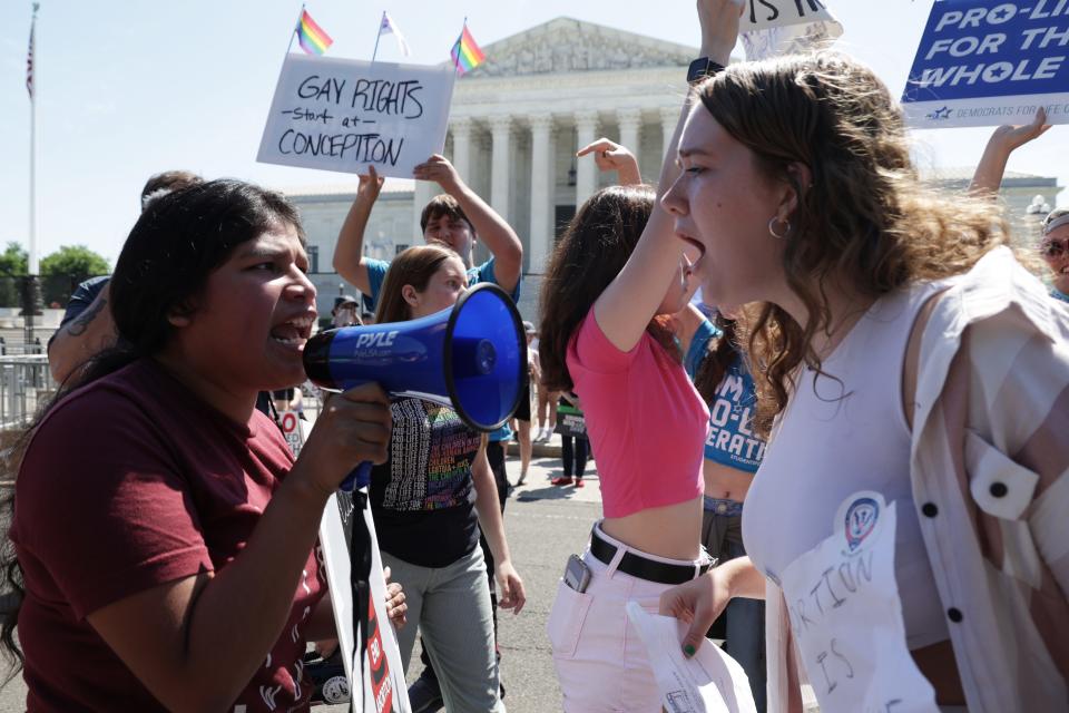 Abortion-rights activists argue with an anti-abortion activist in front of the Supreme Court on June 25 in Washington.