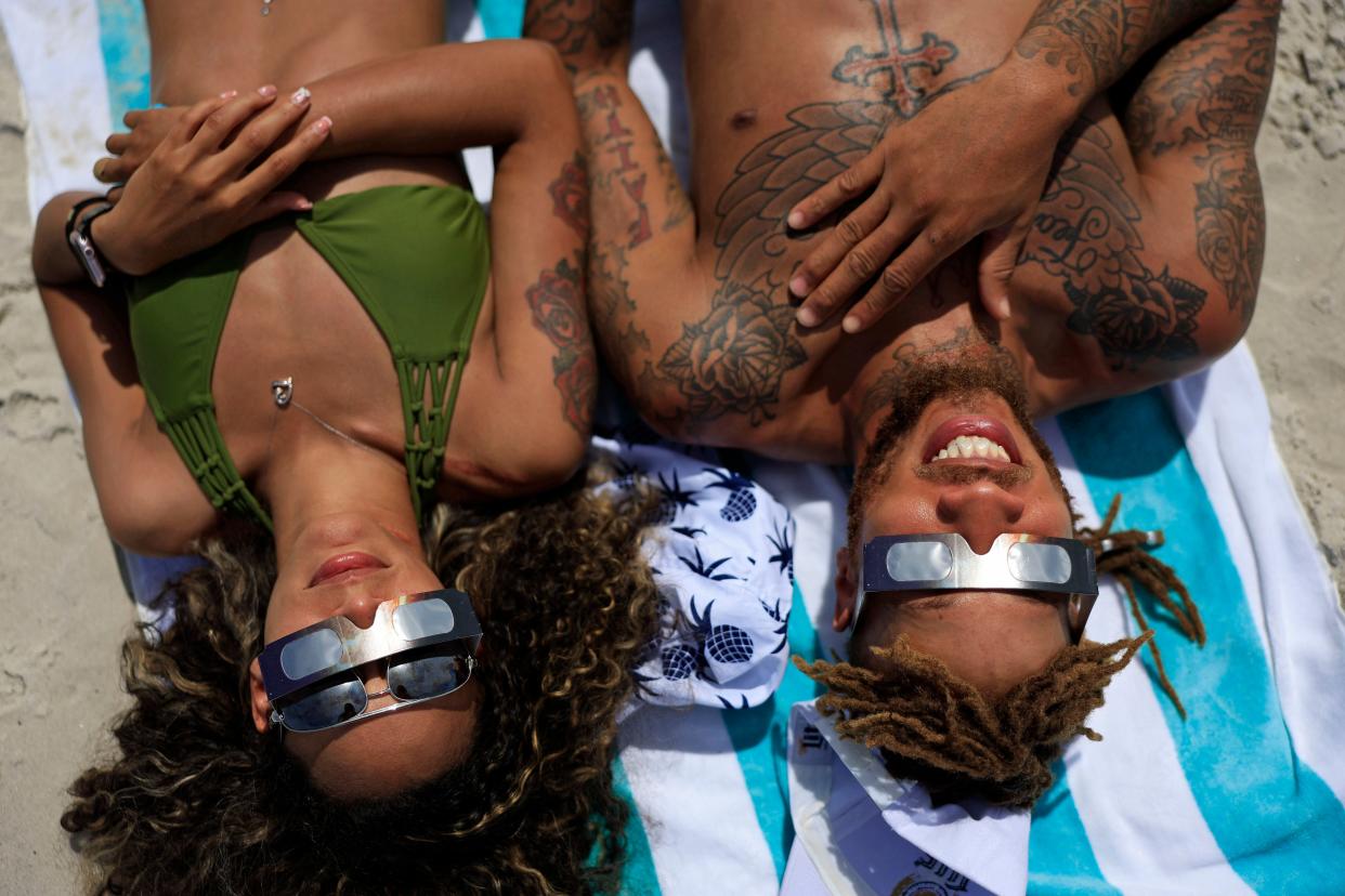 Laquishia Ferguson of Williston, Fla. and boyfriend Easy Ash, of Gainesville, Fla. view their first solar eclipse Monday, April 8, 2024 at Jacksonville Beach, Florida. Ash said he came for “spiritual reasons.” Ferguson said, “I’m wowed.”