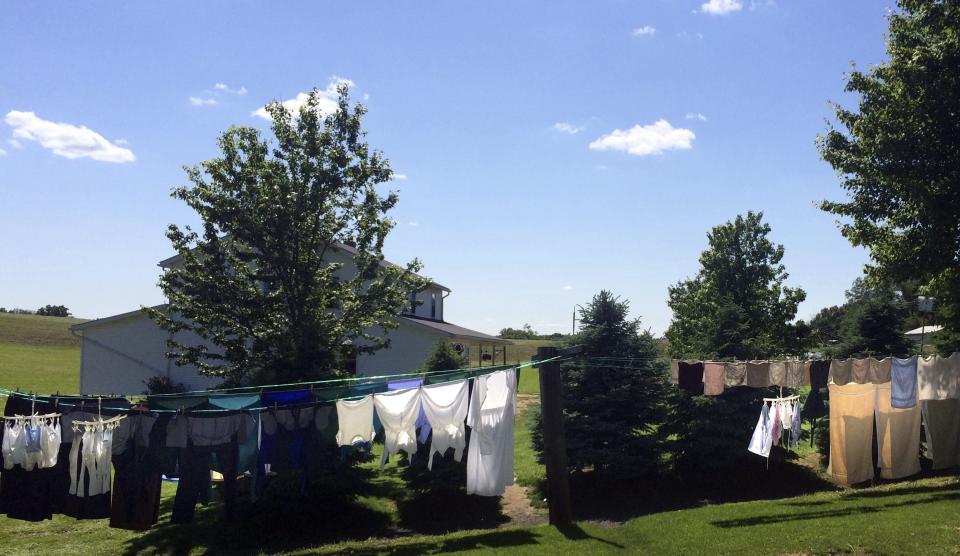 Laundry hangs between the homes of Kathryn and Raymond Miller and Nancy and Freeman Burkholder in Bergholz, Ohio June 6, 2014. The Millers, members of an Amish breakaway sect from eastern Ohio at the center of shocking 2011 hair-cutting attacks on other Amish followers, are trying to settle back into life at home after being exposed in prison to a world their religion is focused on locking out. Picture taken June 6, 2014. To match feature USA-AMISH/ REUTERS/Kim Palmer (UNITED STATES - Tags: SOCIETY CRIME LAW RELIGION)