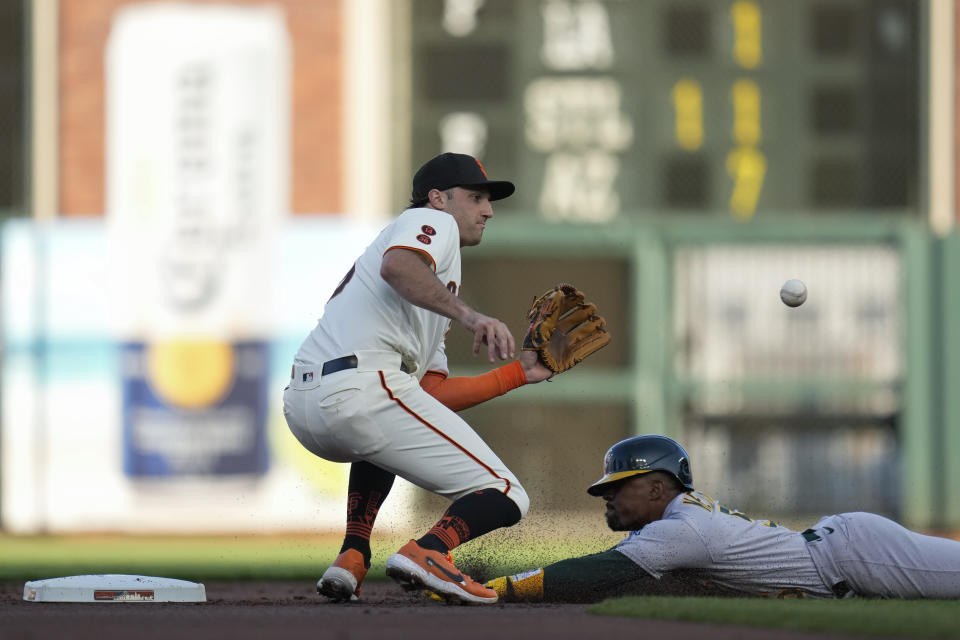 Oakland Athletics' Tony Kemp, right, steals second next to San Francisco Giants second baseman Casey Schmitt during the first inning of a baseball game, Wednesday, July 26, 2023, in San Francisco. (AP Photo/Godofredo A. Vásquez)