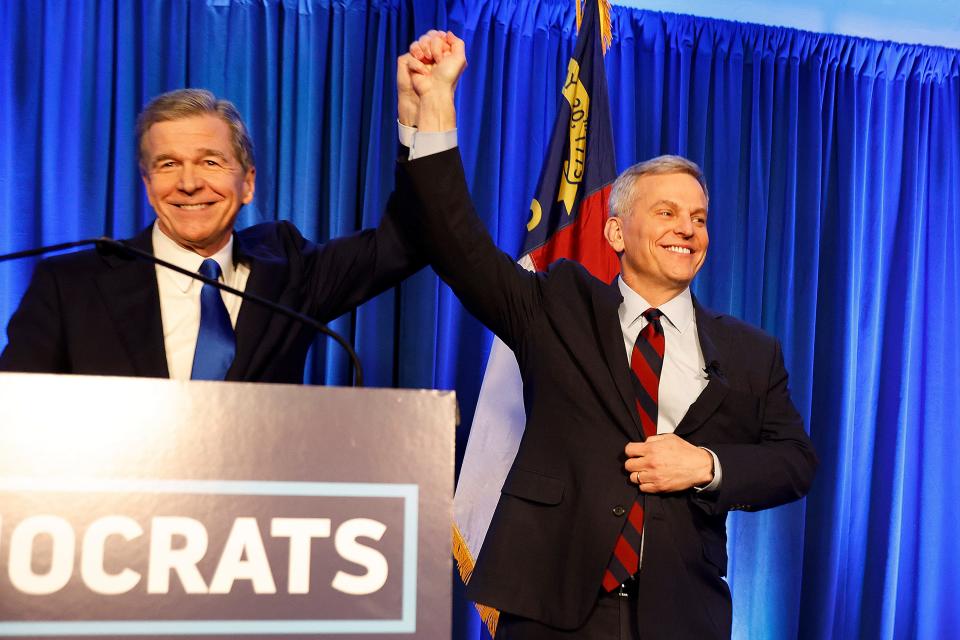 Democratic North Carolina gubernatorial candidate Josh Stein, right, is introduced by North Carolina Gov. Roy Cooper at a primary election night party in Raleigh, N.C., Tuesday, March 5, 2024.