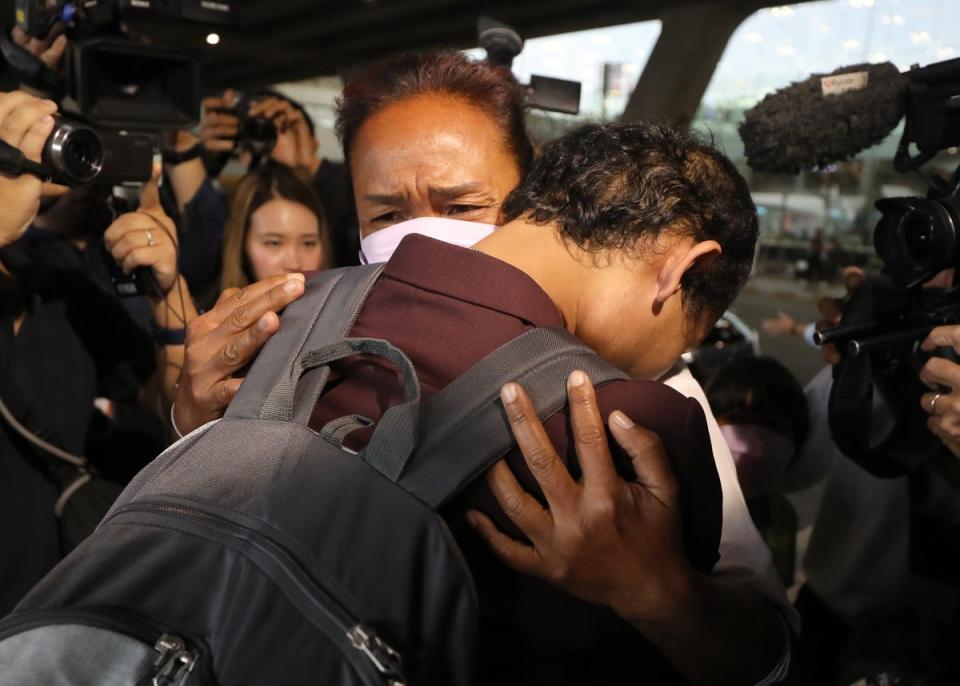 Thai migrant worker Phonsawan Pinakalo (L), who was taken hostage by the Palestinian militan group Hamas in the 07 October attacks on Israel, hugs his mother (EPA)