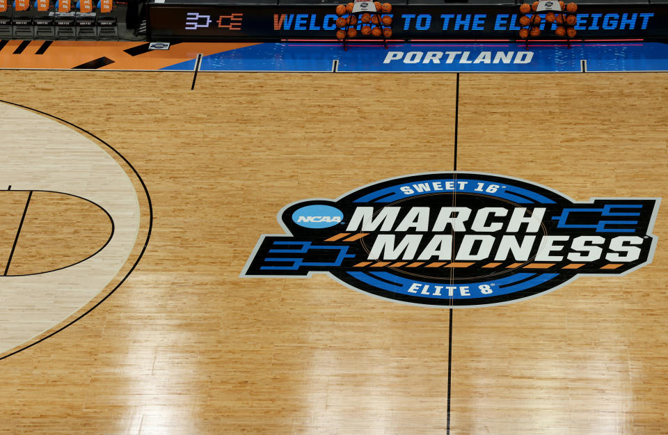 PORTLAND, OREGON - APRIL 01: The three-point line and its measurement discrepancy is adjusted ahead of the Elite 8 round of the NCAA Women's Basketball Tournament between the UConn Huskies and the USC Trojans at Moda Center on April 01, 2024 in Portland, Oregon. (Photo by Steph Chambers/Getty Images)