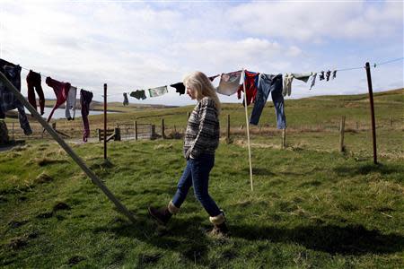 Sue White, 51, poses for a photograph in the garden of her croft near the village of Scalloway on the Shetland Islands April 1, 2014. REUTERS/Cathal McNaughton