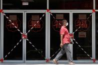 A man passes a closed off mall amid the coronavirus disease (COVID-19) outbreak in Singapore