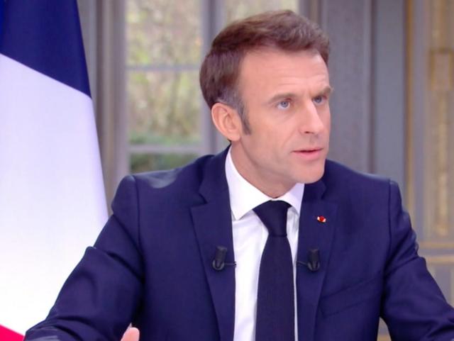 Emmanuel Macron could be seen removing his watch during the televised interview (screengrab)