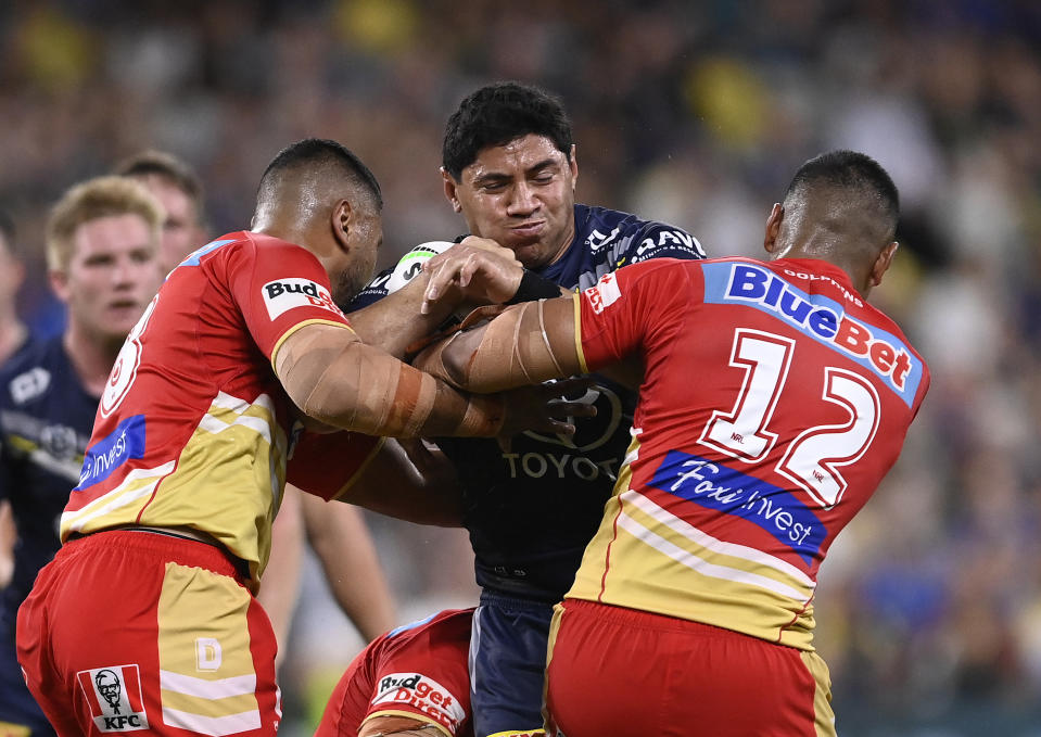 TOWNSVILLE, AUSTRALIA - APRIL 07: Jason Taumalolo of the Cowboys is tackled during the round six NRL match between North Queensland Cowboys and Dolphins at Qld Country Bank Stadium on April 07, 2023 in Townsville, Australia. (Photo by Ian Hitchcock/Getty Images)